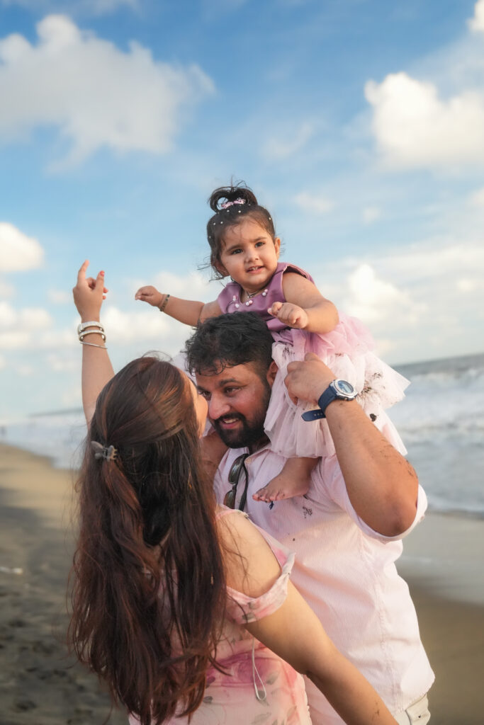 Happy family of three posing together during an outdoor photoshoot in Kochi.