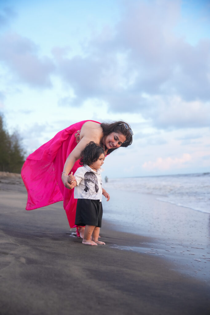 Mother sharing a joyful moment with her child during an outdoor photoshoot.