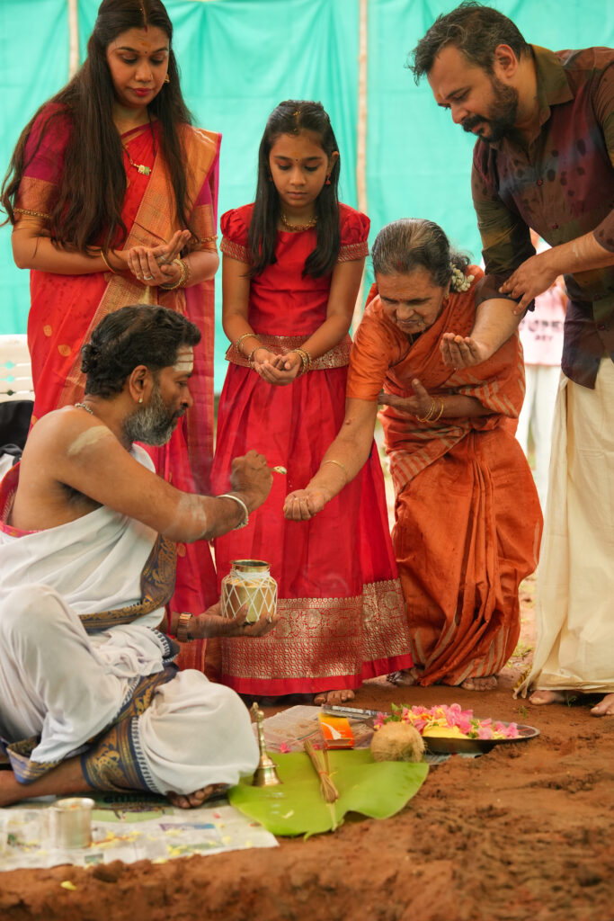 Traditional Kallidal ceremony photography in Kochi with sacred pooja and first stone laying rituals.