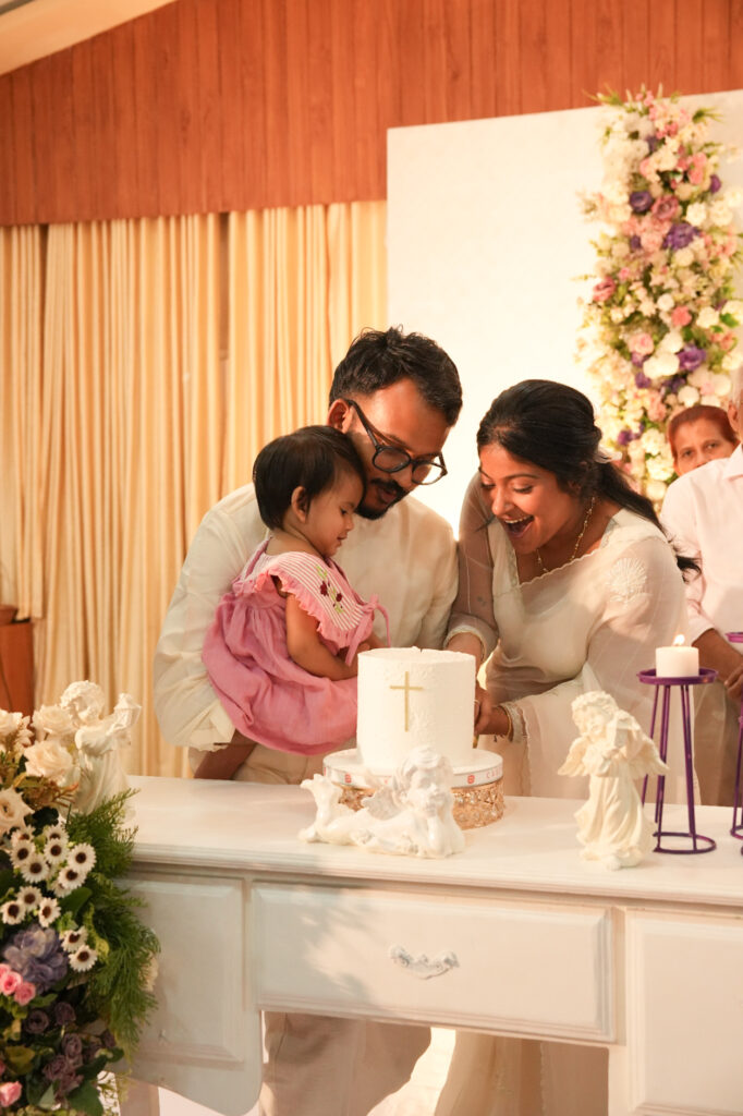 Candid baptism photography in Kochi capturing a baby’s baptism ceremony and family moments in Kerala