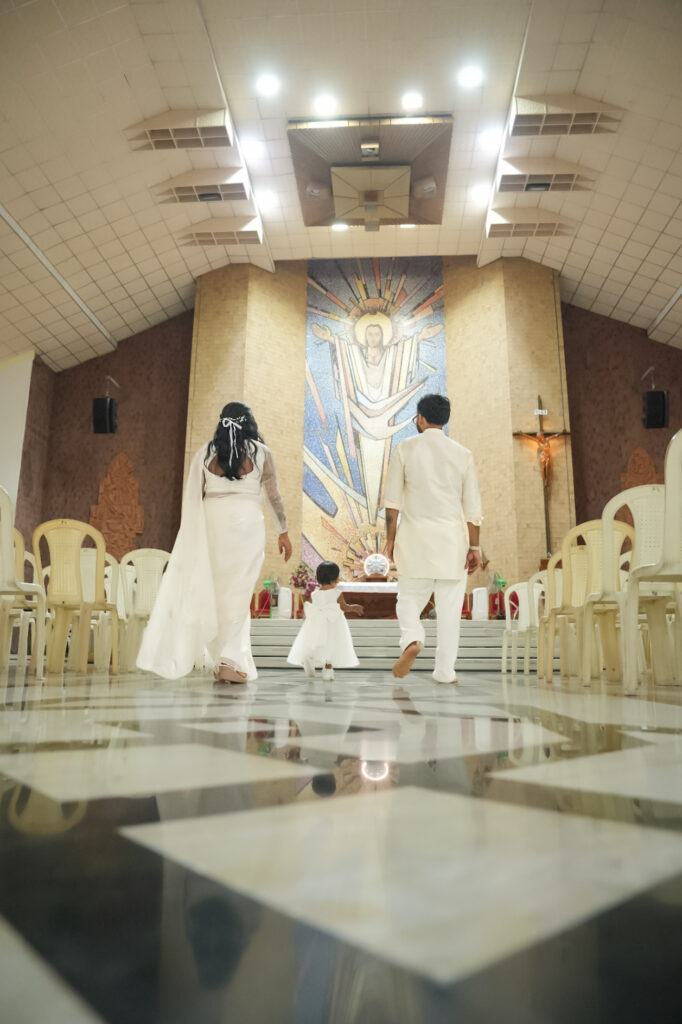 Candid baptism photography in Kochi capturing a baby’s baptism ceremony and family moments in Kerala