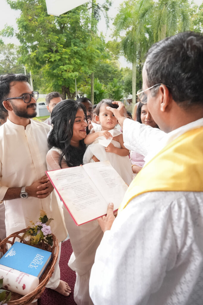 Candid baptism photography in Kochi capturing a baby’s baptism ceremony and family moments in Kerala
