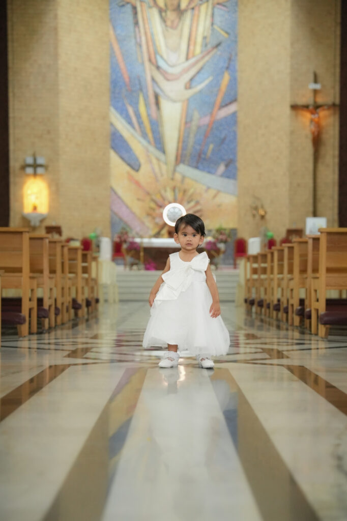 Candid baptism photography in Kochi capturing a baby’s baptism ceremony and family moments in Kerala