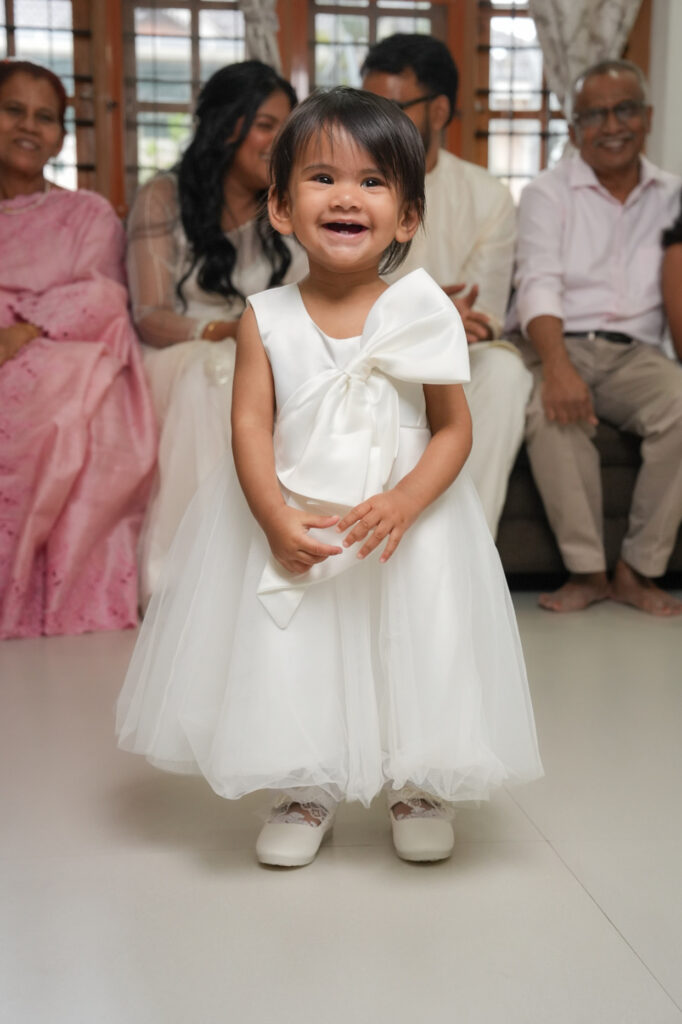 Candid baptism photography in Kochi capturing a baby’s baptism ceremony and family moments in Kerala