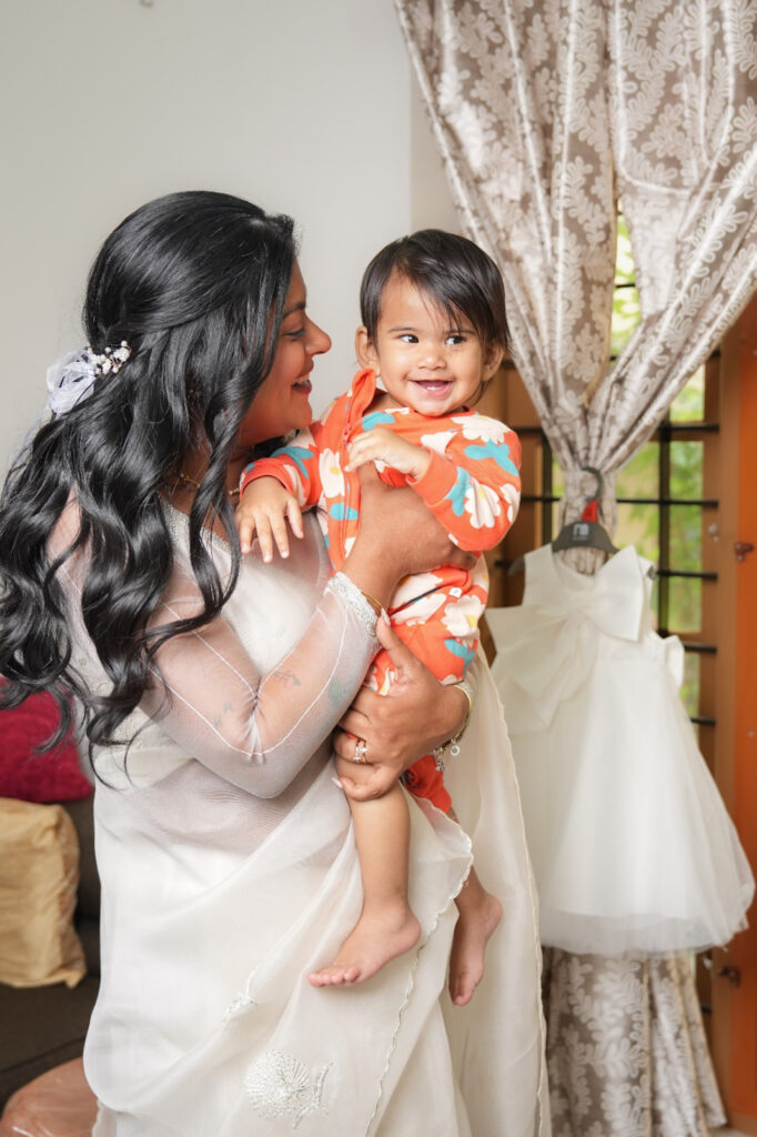 Candid baptism photography in Kochi capturing a baby’s baptism ceremony and family moments in Kerala